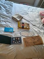 Coins from Royal Canadian Mint 1999 Millennium set laid out on bed including display case, presentation box, coin holders, and packaging.