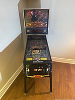 Front view showing cabinet, legs, playfield and backbox