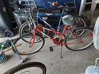 Photo of the SC1800 Supercycle bicycle showing the frame, tires, seat, and handlebar setup in a garage setting.