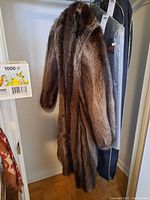 Coat hanging on hanger with garment bags visible