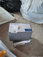 Two Glacier Bay 1500 Series bathroom faucets in original boxes, stacked on floor.