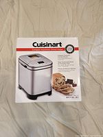 Photo of boxed Cuisinart Compact Automatic Bread Maker CBK-110 showing the product image, brand, model, and key features.