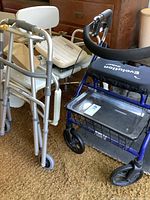 Photo showing the Evolution walker, beige shower seat, and additional health scale partially visible in background