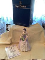 Full view of Jessica figurine in lavender gown with green bows, certificate, and original Royal Doulton box behind.
