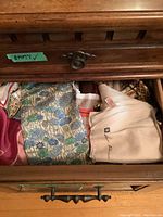 Drawer filled with folded scarves viewed from above