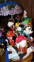 Group shot of multiple nutcracker figurines under Tiffany-style lamp