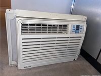 Side view of white Danby Premiere window air conditioner with vents and integrated control panel.