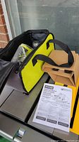 View of the carry bag containing the boxed Ryobi power planer and operator's manual.