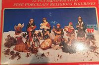 Photo showing all 12 hand-painted porcelain nativity figurines arranged in a nativity scene setup, including kings, angels, Mary, Joseph, baby Jesus, and animals.