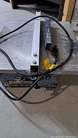 Front view of the King Canada 7 inch tile saw showing the brand label, power cord, and water tray.