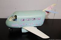 Front side view showing the airplane body with Barbie decals and floral prints.