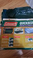Part of the packaging showing the Coleman Quickbed logo and product name along with some product instructions and features.