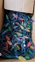 Box of large LED Christmas light sets with textured, multicolored bulb covers.