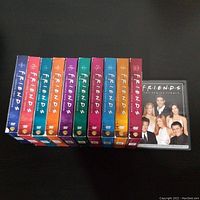 Complete collection of Friends TV show DVD box sets, including Seasons 1 to 10 plus the Series Finale edition, displayed vertically showing colorful spine artwork.