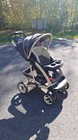 Side view of Graco stroller showing the canopy, seat, storage basket, and wheels.
