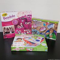Three kids activity kits including Crayola Beadola, Spirograph, and Crystal Growing Geodes, all boxes shown from front.