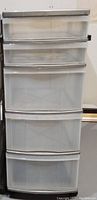 Front view of the plastic rolling storage cart showing five translucent drawers and a metallic gray top handle bar.