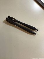 Photo showing the nutcracker laid on a flat surface, highlighting the hinge and handle details