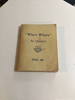 Front cover of the "Who's Where" At Queen's 1947-48 booklet showing the title, year, and Queen's crest.
