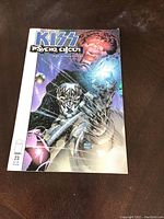 Front cover of KISS Psycho Circus comic showcasing artwork of band members; issue 23.