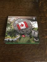 Top view of the coin in its original display case featuring the Canadian flag and 2015 year.