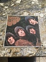 Front cover of the 1966 Beatles Rubber Soul vinyl LP by Capitol Records, showing band members and album title.