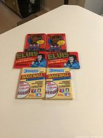 Photo showing unopened packs of 1978 Elvis bubblegum cards, 1987 ALF bubblegum cards, and 1982 Donruss Baseball puzzle and cards.