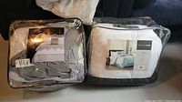 Two packaged comforter sets from EHC and Madison Park, showing packaging and fabric design through clear bags.