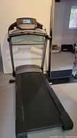 Full view of treadmill showing belt, frame and console