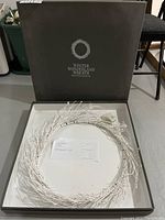 Photo of winter wonderland wreath in original box showing the wreath and packaging.