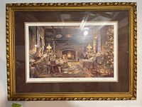 Full view of framed and matted print showing the Christmas cottage scene with ornate gold frame and brown matting.