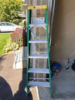 Front view of 6-foot Davidson aluminum ladder, showing green frame, silver steps, and yellow top platform.