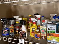Shelf with diverse cleaning supplies including removers, polishes, and cleaners.