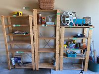 Photo of 3 wood shelving units placed side by side showing overall sizes and shelf counts. Shelves contain various items but are excluded from sale.