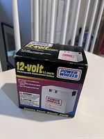 Boxed 12-volt rechargeable Power Wheels replacement battery showing brand, model, and usage details.