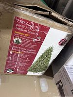 Photo of the original cardboard packaging box showing brand GE, 7.5 ft height, 750 clear lights, Just Cut medium frosted artificial Christmas tree model.
