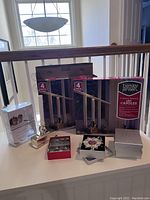 Full lot including boxed LED candles, photo frames, wine charms, and salt and pepper shakers