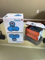 Photo of the boxed Dash smart robot and separate Launcher Kit box on a countertop.