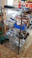 Full view of the metal wire shelving unit loaded with boxes and containers (contents not included)