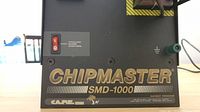Close-up of front control panel showing CHIPMASTER SMD-1000 branding with vacuum pump control switch and grounding post.
