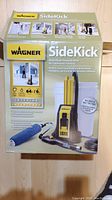 Photo of the unopened Wagner SideKick powered roller box showing the product front with image and features.