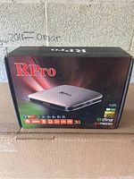 Front of the RPro IPTV Box packaging showing the product image and key features including 1080p support, 3G, DLNA, and multimedia icons.