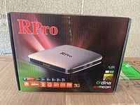 Front view of the RPro Android IPTV Box packaging highlighting main features like video resolution, USB, 3G, and media support.