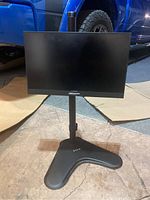 Front view of VIVO floor TV stand with attached 15 inch monitor, showing base and adjustable mounting pole.