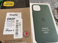 Photo showing OtterBox Prefix Series packaging with drop tested military standard label and recycling info, for iPhone 13.
