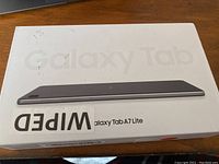 White retail box of Samsung Galaxy Tab A7 Lite with transitional branding and model details, sticker noted as wiped.