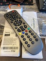 Two brand new Philips Universal Remote Controls in original packaging shown with a close-up of one unit.
