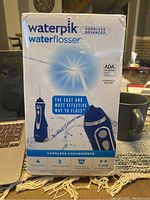Front of box showing product image, brand, features