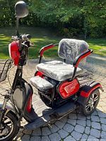 Front left angle showing seat covered in protective plastic and front wheel