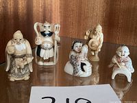 Front view of all five netsuke figures arranged in a row